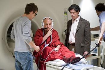 Richard J. Davidson (center wearing jacket) and Antoine Lutz (right) prepare Buddhist monk Matthieu Ricard for MRI test